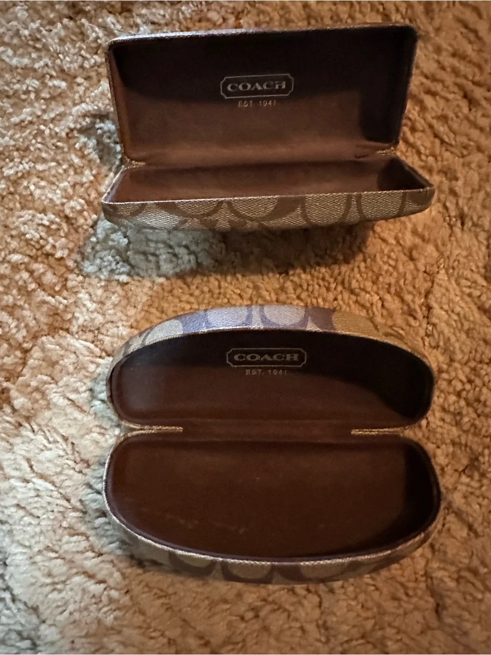 A set of two Coach Signature Canvas Sunglasses Cases in Khaki and Brown